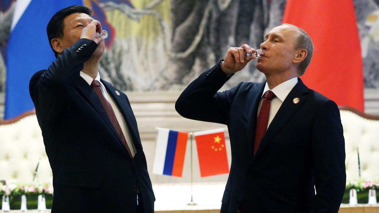 What will Biden do to counter China and Russia? Russian President Vladimir Putin and Chinese President Xi Jinping toast with vodka during a signing ceremony in 2014. Picture: Sasha Mordovets/Getty Images.