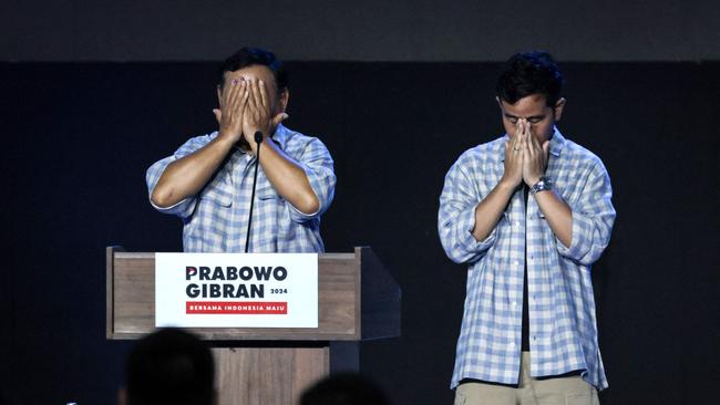 Prabowo Subianto, left, and vice-presidential candidate Gibran Rakabuming Raka pray on stage during a rally in Jakarta. Picture: AFP