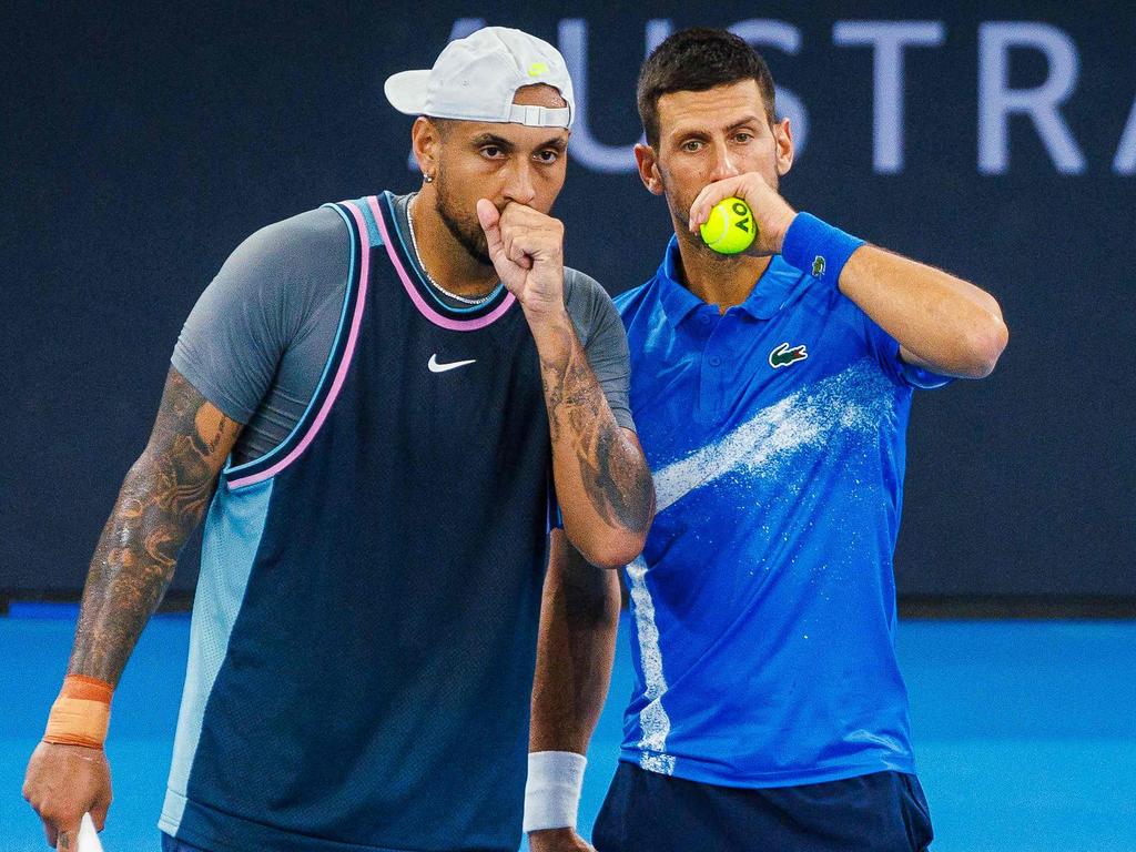 Novak Djokovic speaks with Nick Kyrgios before a point during their men's doubles match at the Brisbane International. Picture: AFP