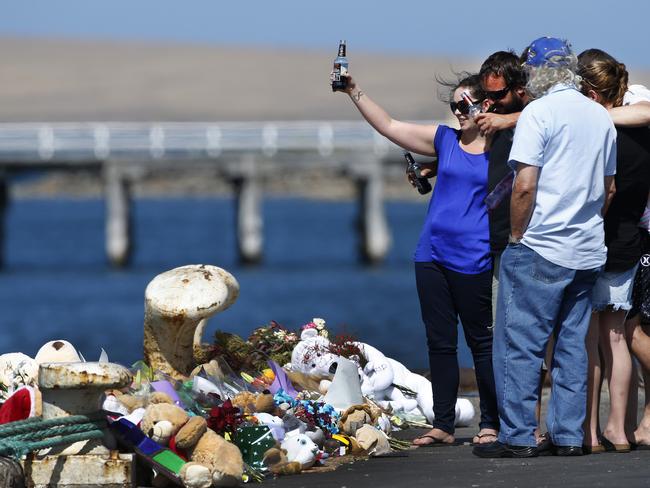 Family members of Damien Little raise a toast to Damien and the boys at the scene. Picture: Dean Martin