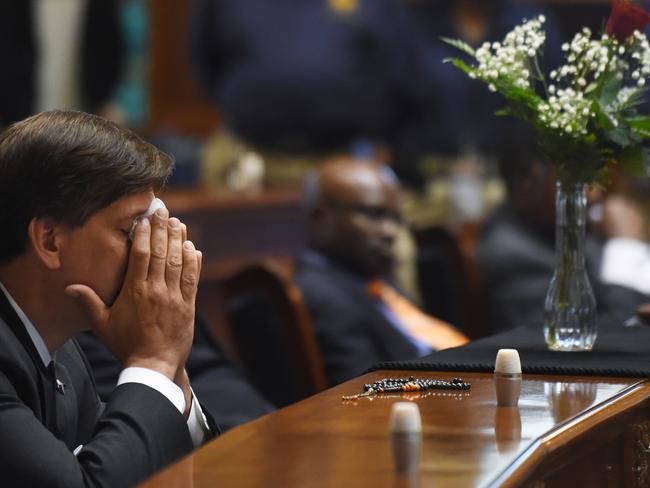 Poignant tribute ... Carolina State Senator Vincent Sheheen gets emotional as he sits next to the draped desk of state Senator Clementa Pinckney on Thursday at the Statehouse in Columbia, South Carolina. Picture: Rainier Ehrhardt/AP