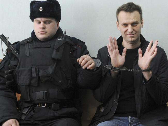 Russian opposition leader Alexei Navalny, right, poses for press in court in Moscow, Russia. Picture: AP