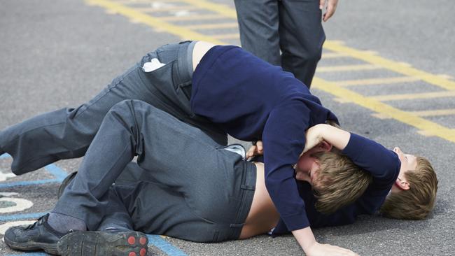 Boys fighting in a school playground ... public schools recorded more than 2000 violent incidents in 2016.