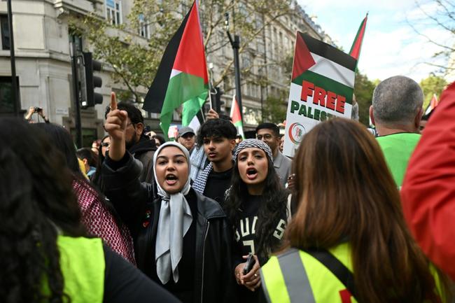 Protesters wave Palestian flags during a rally at the Uskudar Square in Istanbul, Turkey