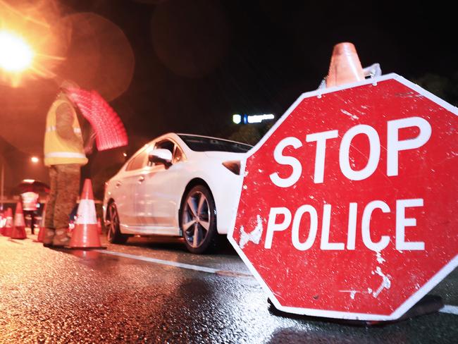 1am August 8 2020, Gold Coast Highway Coolanagatta Queensland - Queensland Police Officers with the assistance of The Australian Army stop all traffic into Queensland for checks at 1am on QLD/NSW border crossing due to increased lockdown of the State of QueenslandScott Powick Newscorp