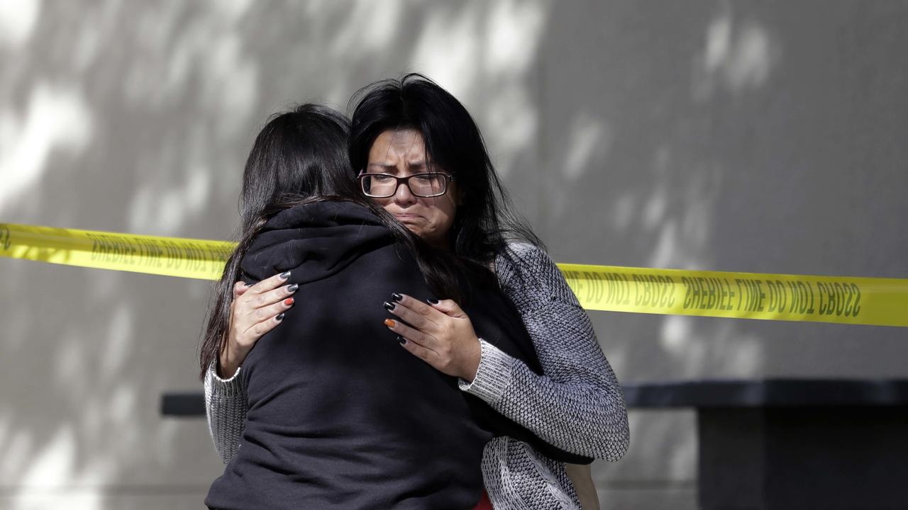 Mourners embrace outside the Thousand Oaks Teen Center where relatives and friends gathered in the aftermath of the Wednesday night mass shooting. Picture: AP