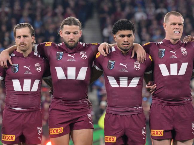 BRISBANE, AUSTRALIA - MAY 28: Cameron Munster, Patrick Carrigan, Robert Toia, Lindsay Collins, Jeremiah Nanai and Xavier Coates of the Maroons line up for the national anthem ahead of game one of the Men's State of Origin series between Queensland Maroons and New South Wales Blues at Suncorp Stadium on May 28, 2025 in Brisbane, Australia. (Photo by Bradley Kanaris/Getty Images)