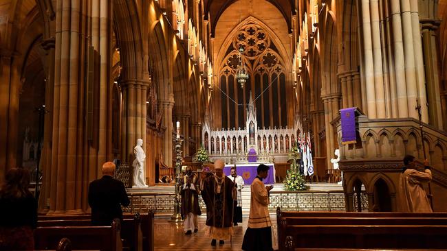 Catholic Archbishop Anthony Fisher, centre, leads a mass at a near-deserted St Mary's Cathedral in Sydney on April 24. Picture: AFP