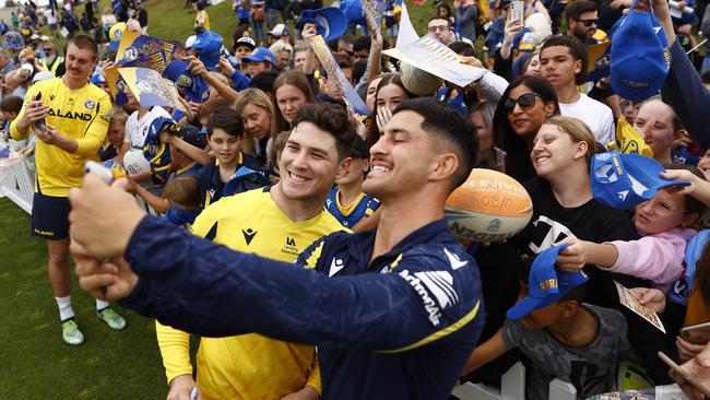 Mitch Moses and Dylan Brown pose for photos with Eels fans. Picture: Richard Dobson