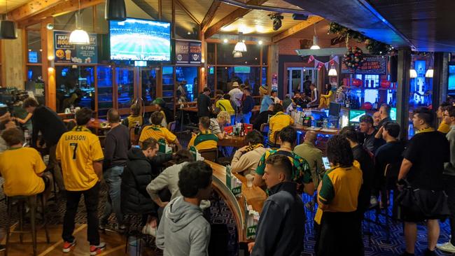 Soccer fans at the Arkaba Hotel celebrate Australia getting through to the knockout stages of the World Cup.