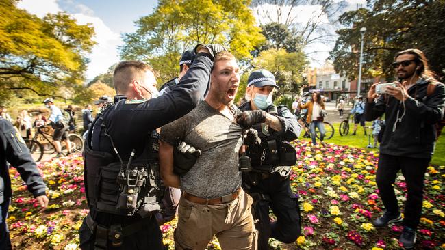 Nikola Dedovic is led away by police in Victoria Park in Chippendale on Saturday. Picture: Julian Andrews