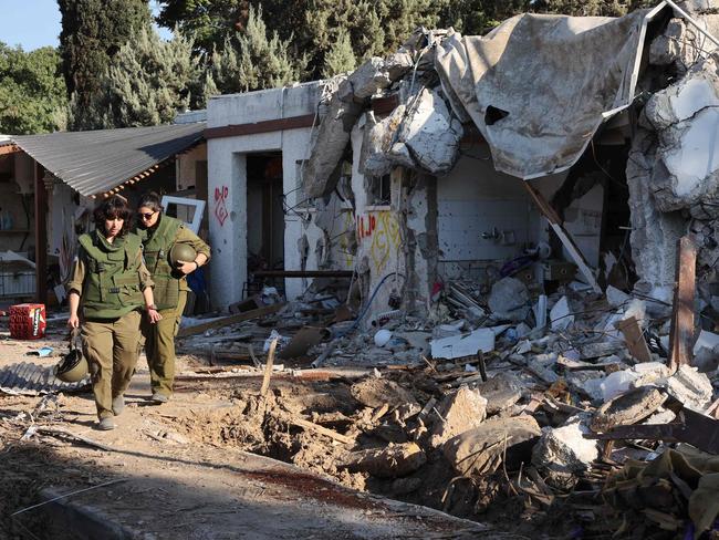 Israeli army soldiers patrol near damaged houses in kibbutz Kfar Aza in southern Israel near the Gaza Strip on October 18, 2023. Picture: AFP