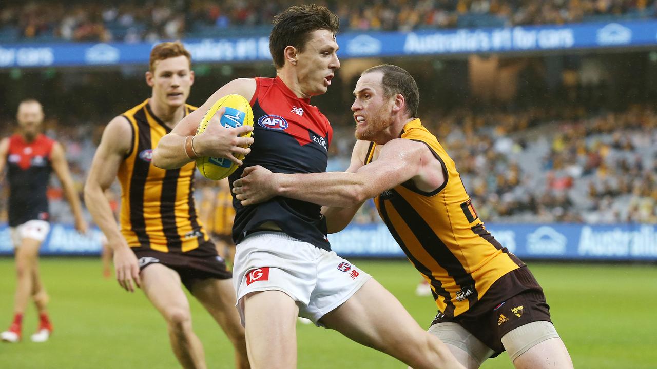 Melbourne’s Jake Lever is tackled by Hawthorn’s Jarryd Roughead. Photo: Michael Klein