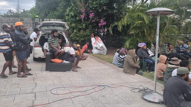 South Sea Islanders plea for help from the Department of Employment during a visit to a Bundaberg motel in June 2022.