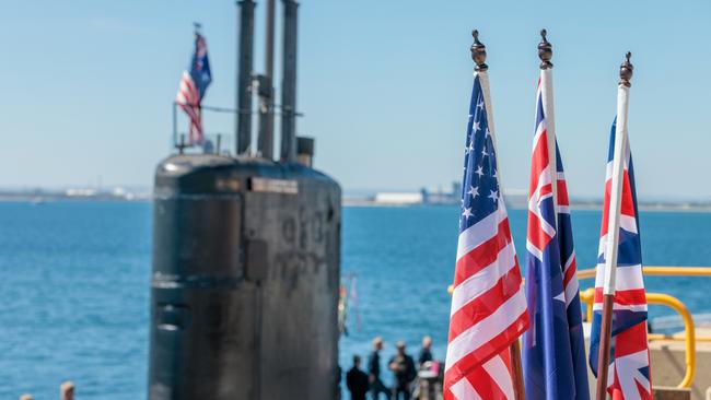 National flags of the USA, Australia and Great Britain in front of the nuclear submarine USS Asheville. Picture: NCA NewsWire / pool / Richard Wainwright