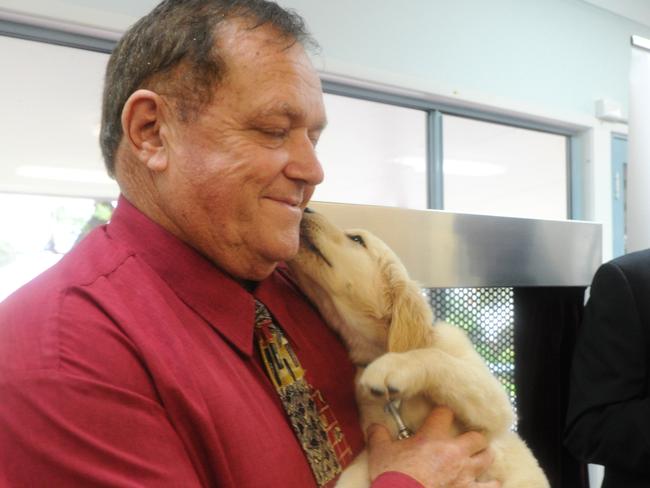 Ron Woodham at the Emu Plains Correctional Centre in 2014. The centre was the first facility of it's kind to incorporate the breeding of assistance dogs into its program. "Ronnie" the pup took a shine to his namesake Woodham.