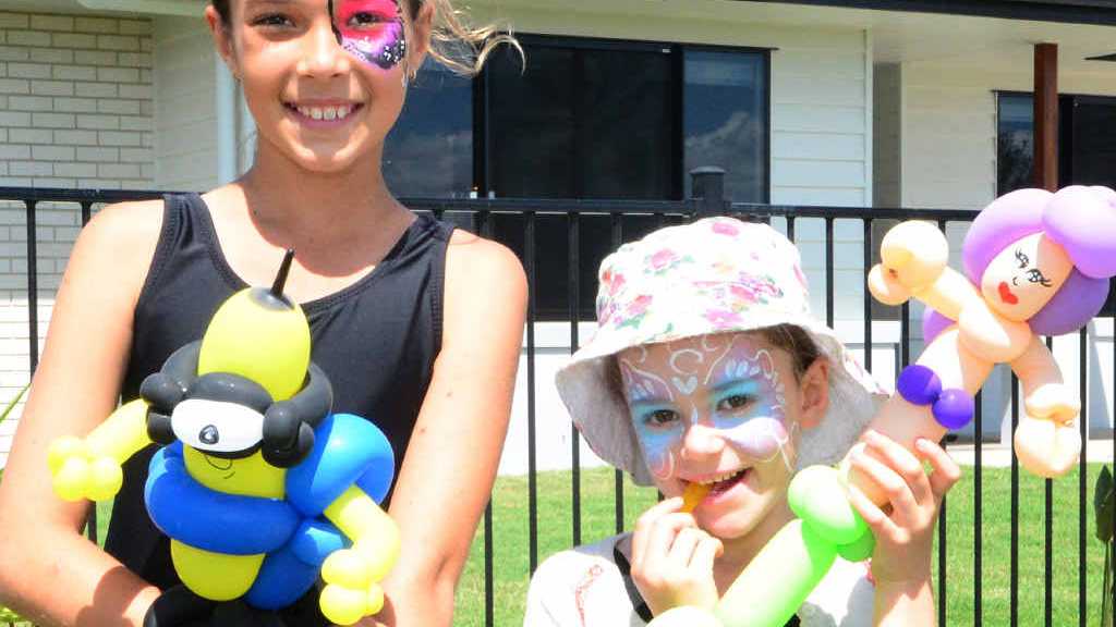 HAPPY DAY: Nya Minto and Lilla McIntyer get their faces painted at the official opening of the Pines display village in Yeppoon.