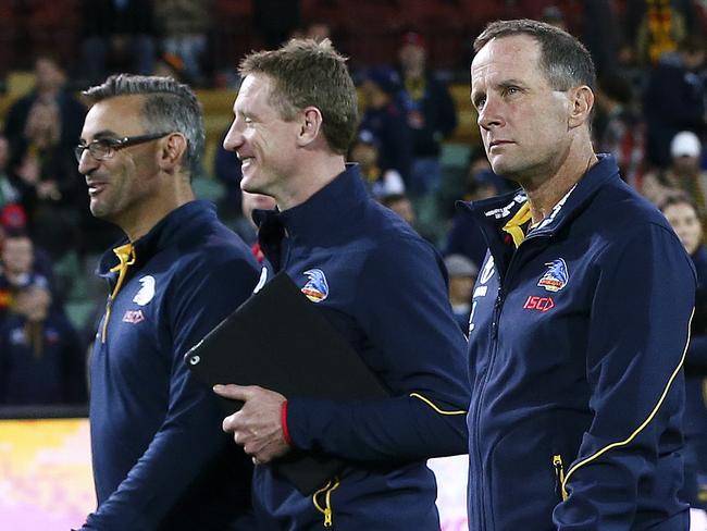 28/04/18 - AFL - Round 6 - Adelaide Crows v Gold Coast Suns at the Adelaide Oval. Don Pyke and his coaching team Scott Camporeale and Brett Burton and Ben Hart (far left looking at ground) walk off after the win. Picture SARAH REED