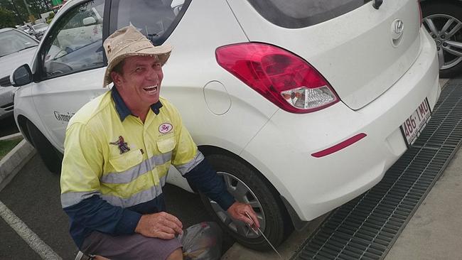 In a random act of kindness Reg Gilroy helped The Gympie Times photographer fish her car keys out of the drain. 