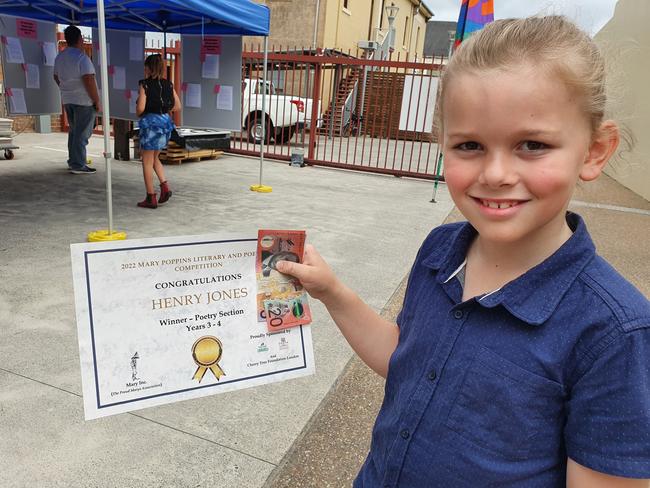 Henry Jones happily shows his certificate and cash after winning the poetry section for Grades 3 to 4 with his entry titled My Imagination.