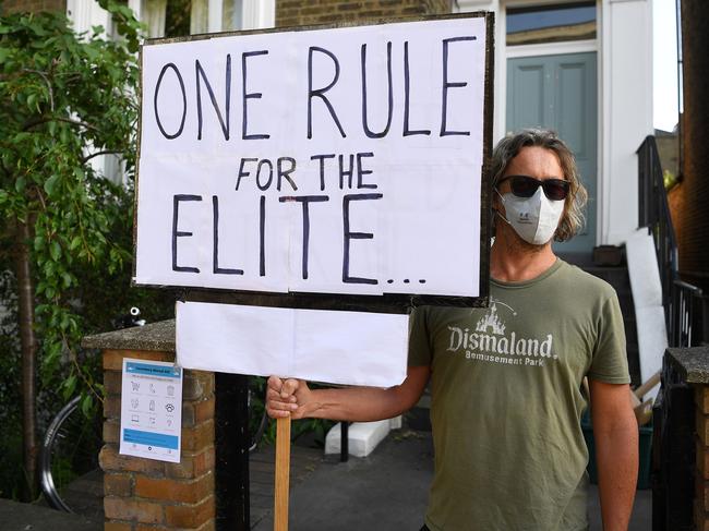 Demonstrators hold placards as they protest outside of the home of 10 Downing Street special advisor Dominic Cummings, in London. Picture: AFP