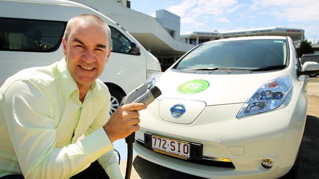 Developer Danny Andrews with a Nissan Leaf electric car.