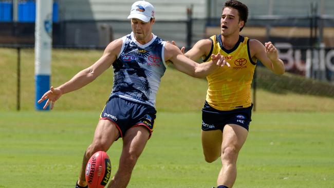 ON THE RUN: Adelaide defender Luke Brown breaks clear of rookie-list teammate Lachlan Murphy during training at Bond University on the Gold Coast. Picture: Adelaide Football Club.