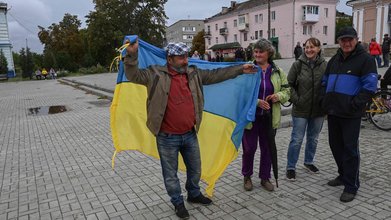 A man waves a Ukrainian flag in Izyum, Kharkiv Region, eastern Ukraine, on September 14, following its liberation from Russia. Picture: Juan Barreto/AFP