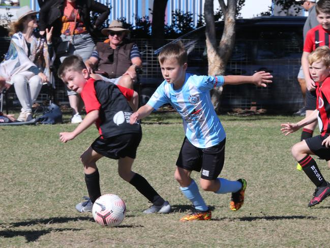 Under-9s Football: Palm Beach (Blue) v Burleigh (Red) at Mallawa Sports Complex on July 10 2021. Picture: Mike Batterham