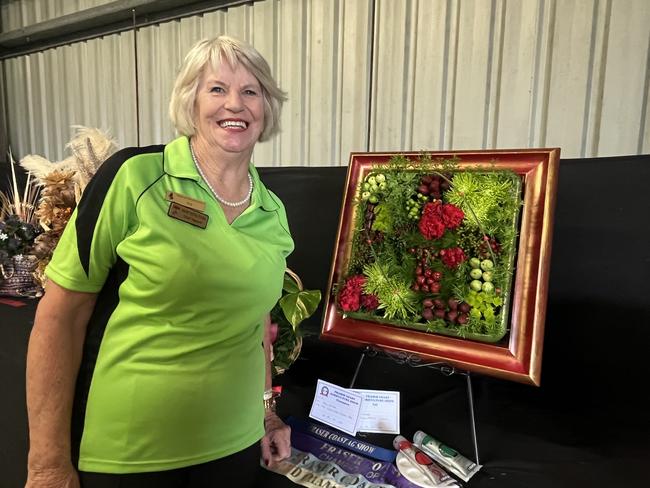 Joy Duke with the floral display, which was judged Champion of the competition at the Fraser Coast Show.