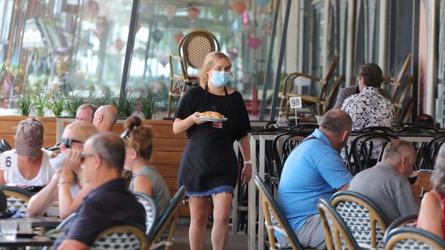 Social distancing and mask wearing in the Broadbeach Mall earlier this year - restrictions will lift completely from December 17 for the vaccinated. Picture: Glenn Hampson