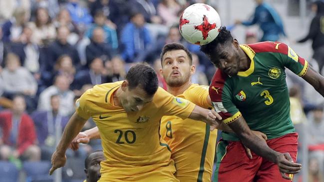 Trent Sainsbury (L) competes for the ball with Cameroon's Andre-Frank Zambo Anguissa.