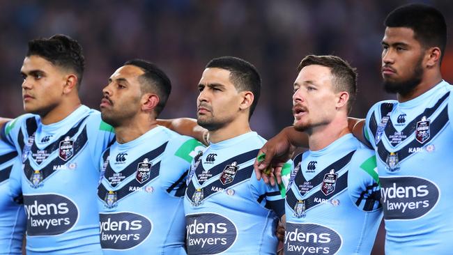 From left, Blues players Latrell Mitchell, Josh Addo-Carr, Cody Walker and, on the right, Payne Haas remain silent while Damien Cook sings the anthem. Picture: Getty Images