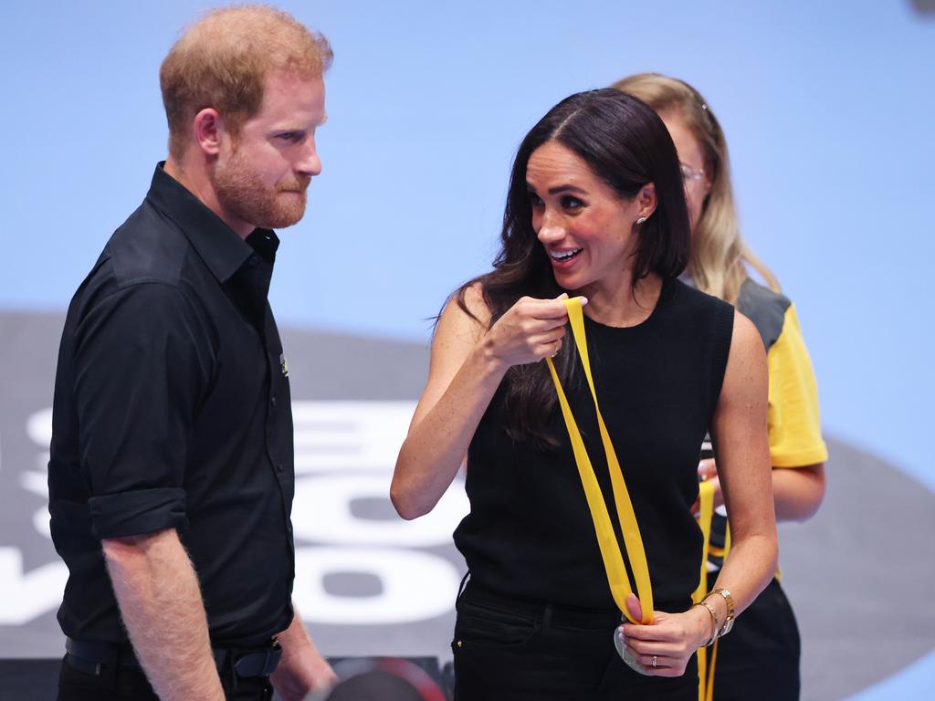 The Duchess of Sussex prepares to hand out medals. Picture: Getty Images