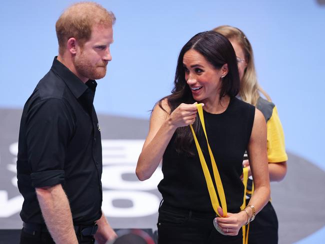 The Duchess of Sussex prepares to hand out medals. Picture: Getty Images