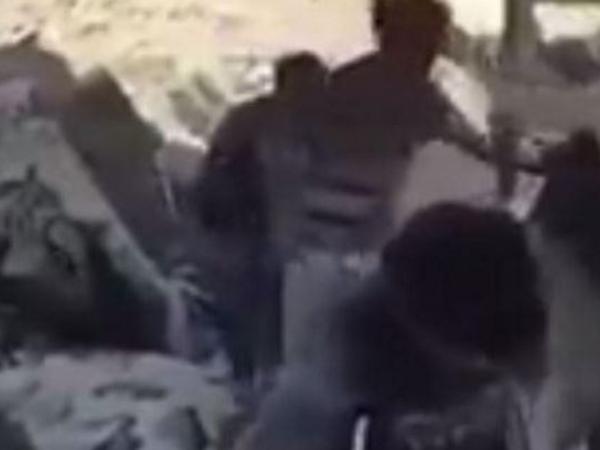 Video footage shows several suspected ISIS fighters emerging from hiding.