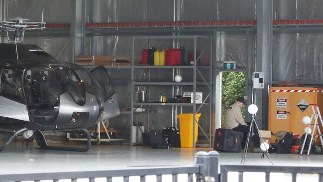 ATSB officers continue their helicopter crash investigations at the Seaworld Helicopter Hangar on the Spit. Picture Glenn Hampson.