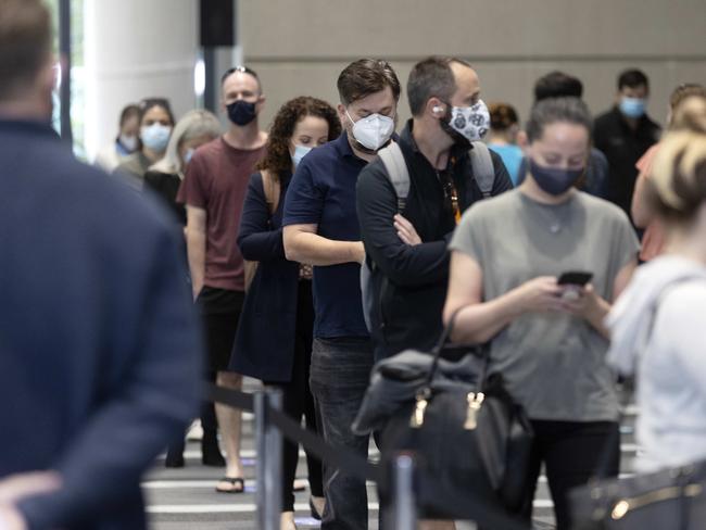 BRISBANE AUSTRALIA - NewsWire Photos AUGUST 11, 2021: People line up for their Pfizer vaccine at the  Convention and Exhibition Centre where the new mass vaccination hub opens for its first day. NCA NewsWire / Sarah Marshall