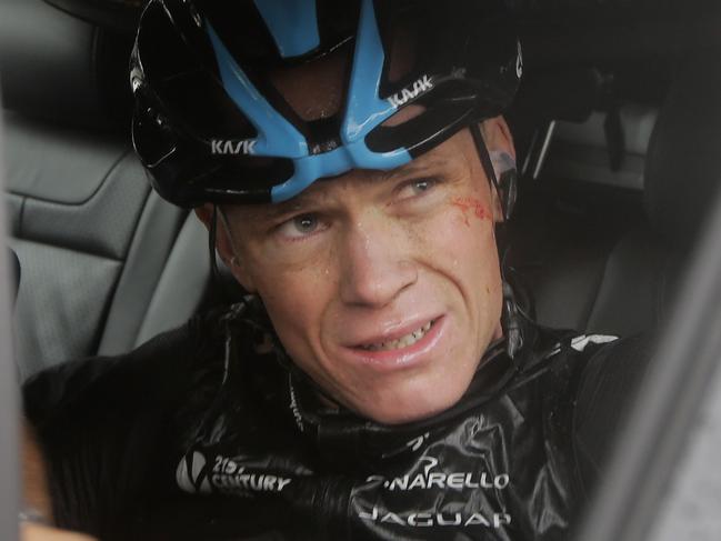 Britain's Christopher Froome gets into his team car as he abandons the race following a third consecutive crash in two days during the fifth stage of the Tour de France cycling race over 155 kilometers (96.3 miles) with start in Ypres, Belgium, and finish in Arenberg, France, Wednesday, July 9, 2014. The stage initially contained nine sectors of cobblestone roads dreaded by the majority of the riders in the pack especially under wet conditions, the organization decided to cancel two of the nine stretches because of the weather. (AP Photo/Laurent Cipriani)