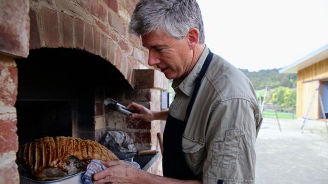 Evans working the outdoor oven.