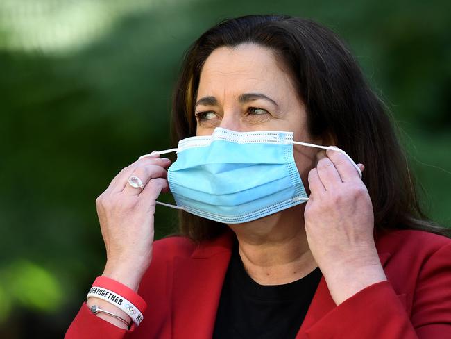 BRISBANE, AUSTRALIA - NewsWire Photos - AUGUST 8, 2021. Queensland Premier Annastacia Palaszczuk puts on her mask during a media conference at Parliament House to provide a Covid-19 update.Picture: NCA NewsWire / Dan Peled