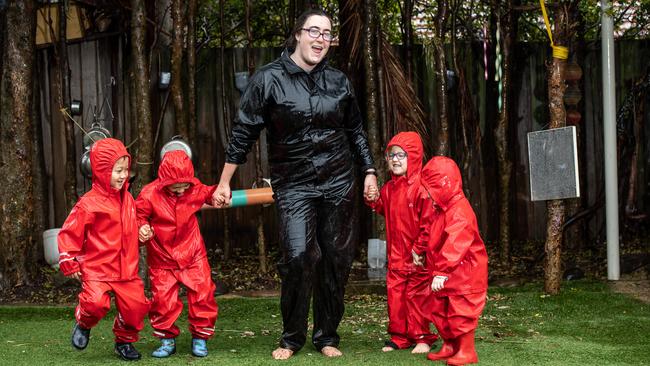 Ray Yang, Vincent Byron, Fiona Weekes, Ella Hallen-Taylor and Sia Dunbar enjoying the rain at Tigger’s Honeypot. Picture: Monique Harmer