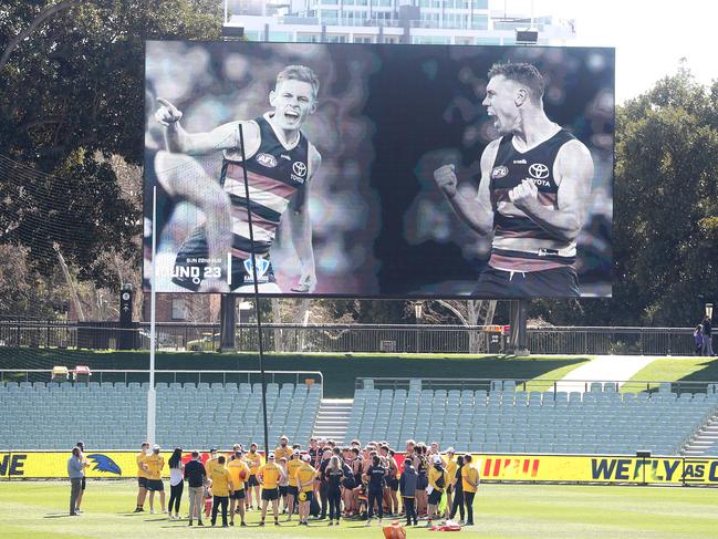 The Crows pay tribute to David Mackay and Tom Lynch on the scoreboard at training. Picture: Sarah Reed