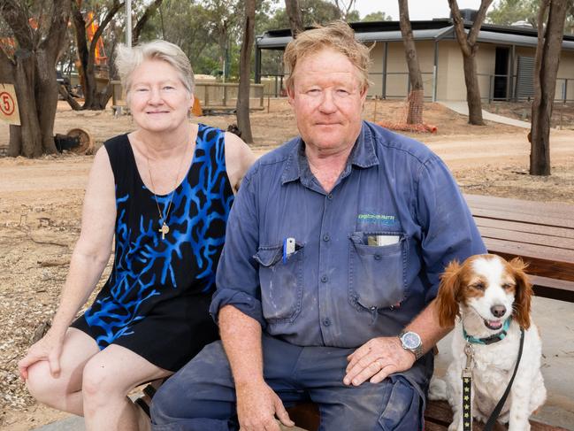 Kingston-on-Murray Caravan Park, owner Barbara and Geoff Calvert with their dog Arya. The park is still not open 12 months after last year's River Murray flood destroyed their park. Tuesday, December 12, 2023. (The Advertiser/ Morgan Sette)