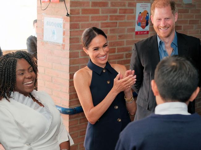 Meghan and Harry talking with a student of the Popular Cultural School in Bogota. Picture: Andres Castilla / Colombian Vice-Presidency / AFP