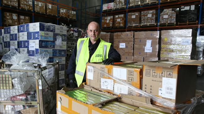 Australian Border Force officer Antony Wigoder with some of the 739,000 seized nicotine vaping products. Picture: Britta Campion / The Australian