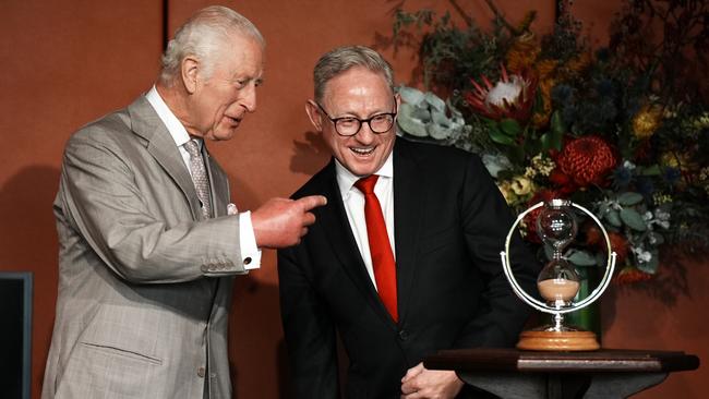 Legislative Council president Ben Franklin watches as King Charles III turns an hourglass he is presenting as a gift at New South Wales Parliament House. Picture: Getty