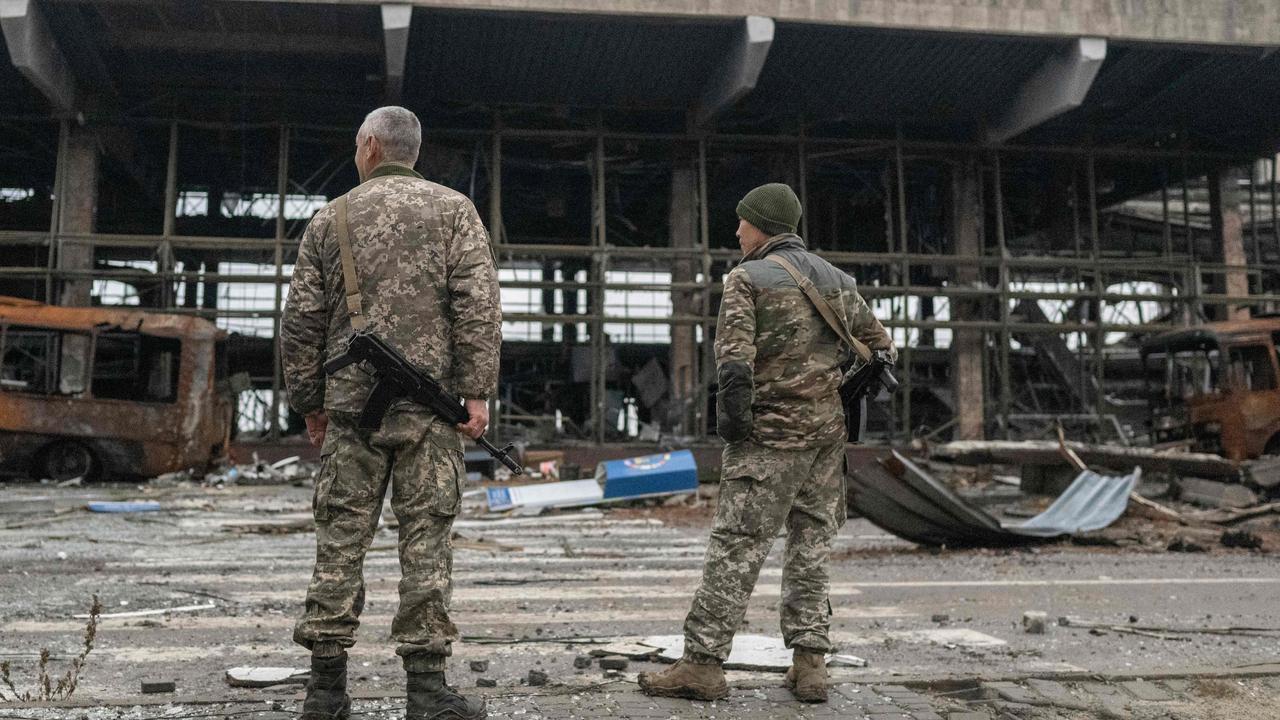 Ukrainian soldiers stand in front of a destroyed building of the International Airport of Kherson in the village of Chornobaivka, outskirts of Kherson. Picture: AFP.