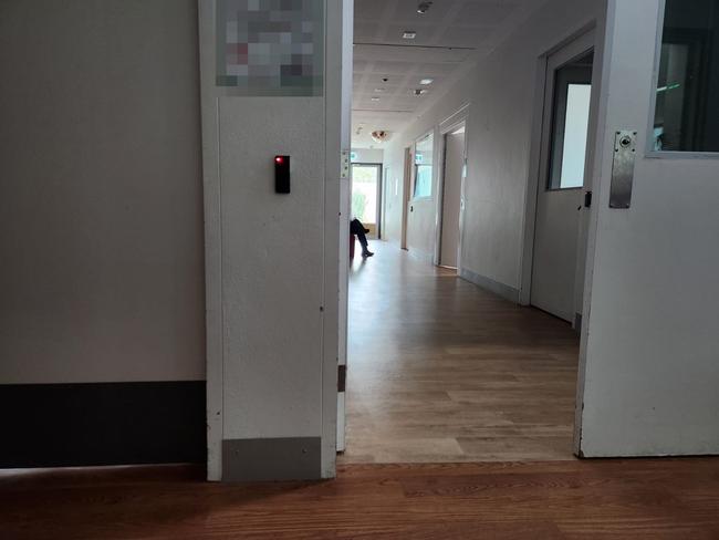 A security guard sits in a psychiatric inpatient ward outside the door of a mother who has just given birth. Picture: Supplied