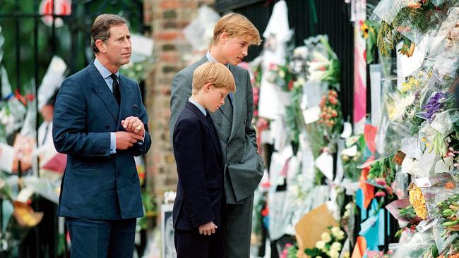 Charles, Prince William and Prince Harry look at floral tributes to Diana, Princess of Wales outside Kensington Palace in 1997. Picture: Anwar Hussein/WireImage